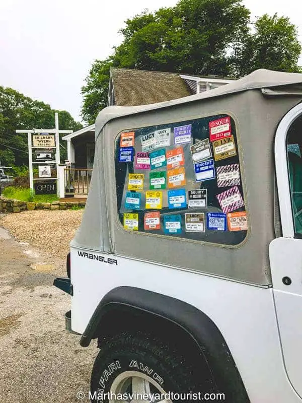 An island car festooned with beach stickers collected over the years.