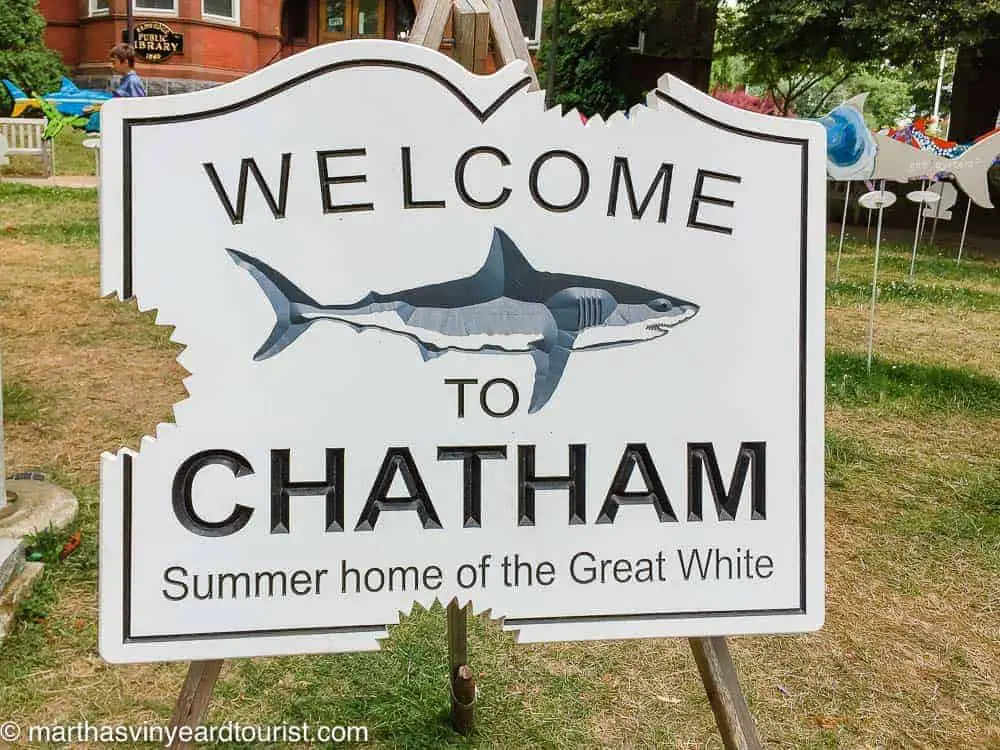 A welcome to Chatham sign with shark bite marks