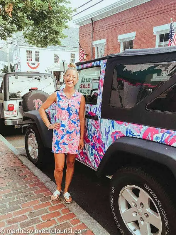 A Lily Pulitzer employee posing in front of a Lily Pulitzer jeep