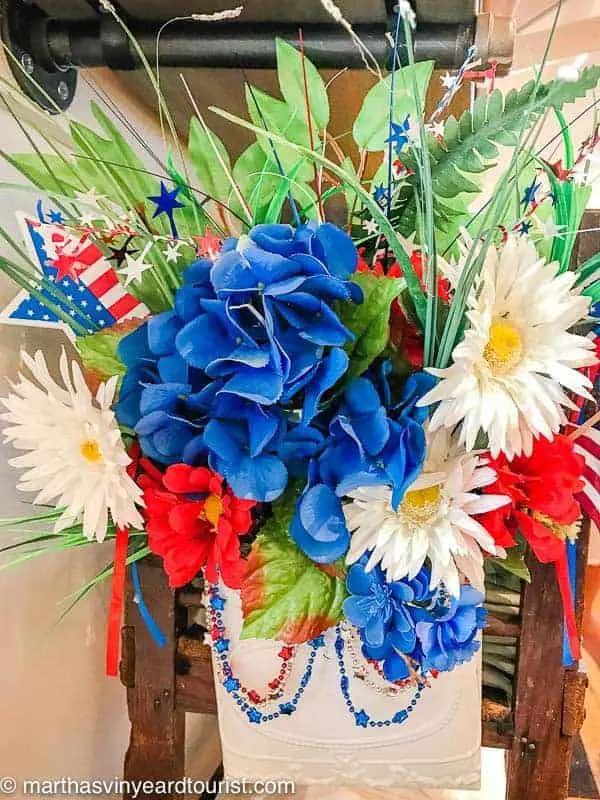 flowers and flags in patriotic July Fourth setting