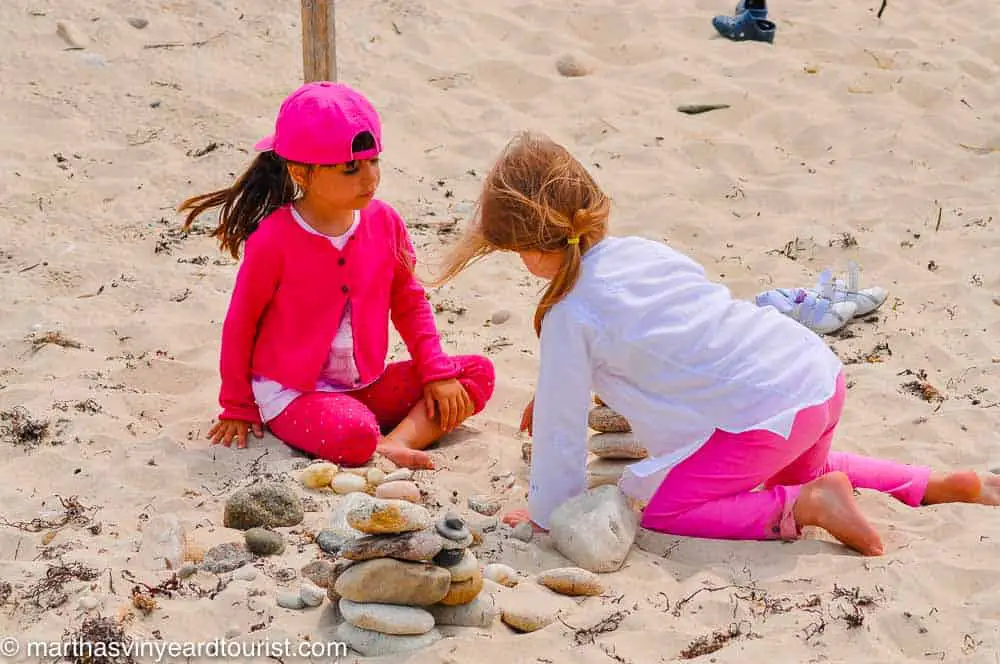 two girls collecting stones on the beach