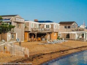 beach in front of Vineyard Harbor Motel with sun recliners on the sand