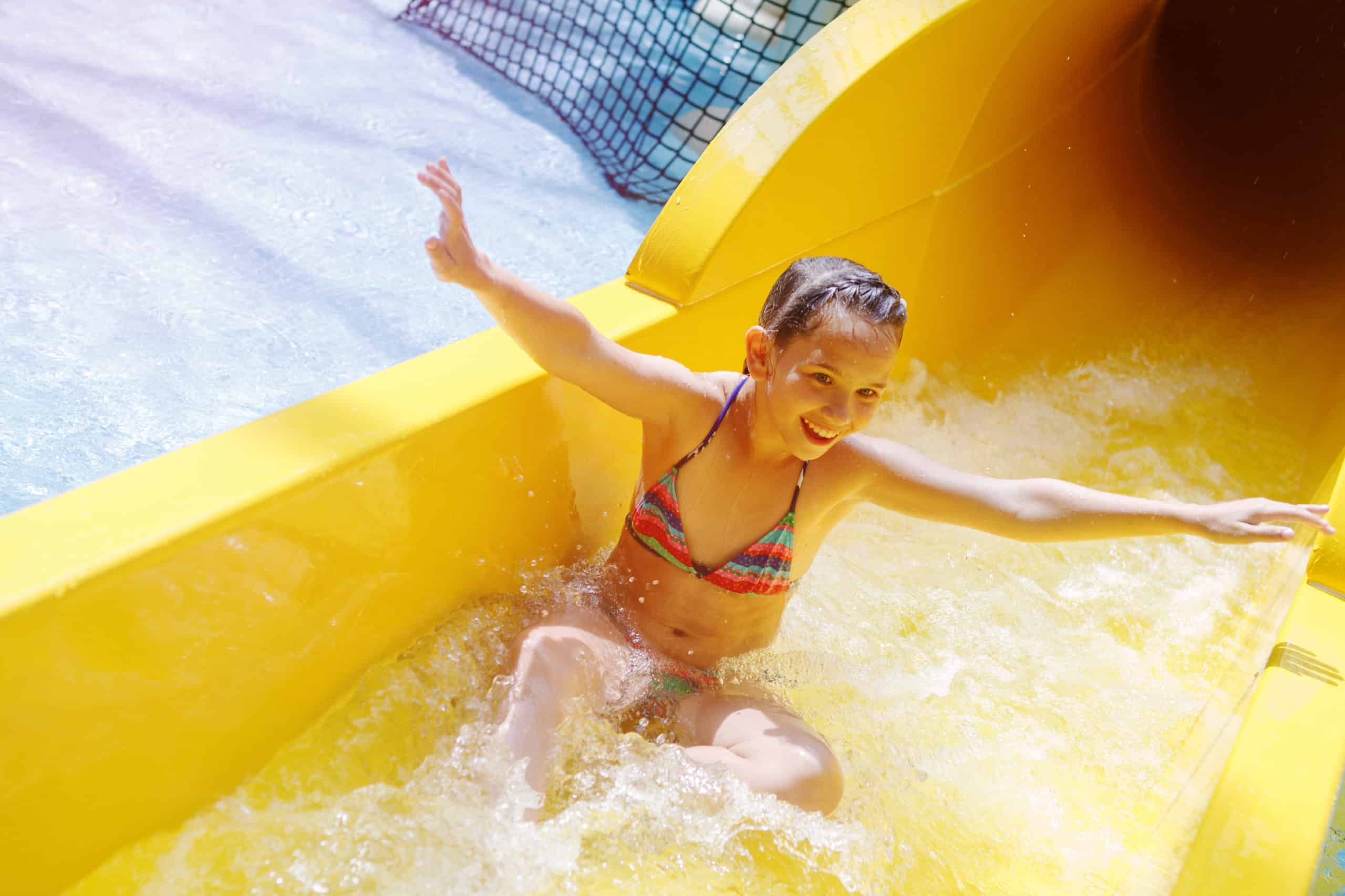 Girl on yellow water slide