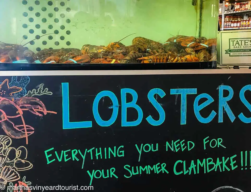 a lobster tank with a sign advertising a clambake