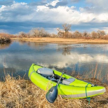 green inflatable kayak in the marsh