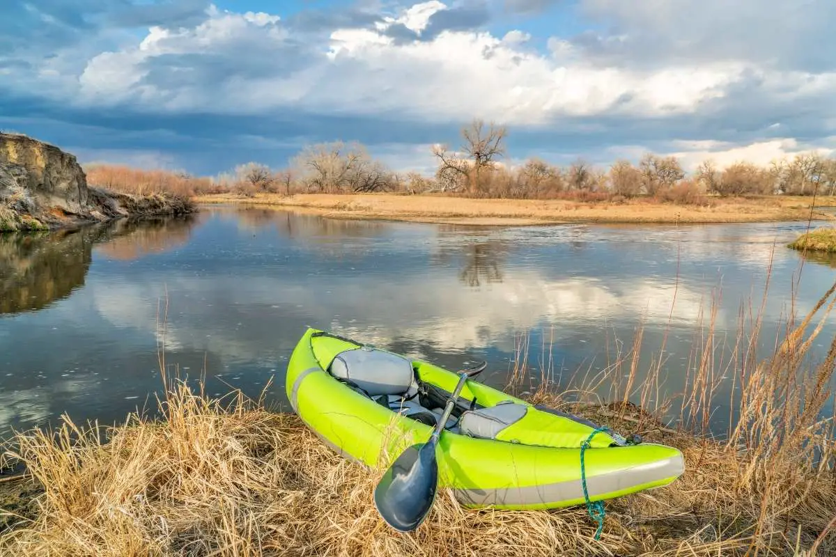 green inflatable kayak in the marsh