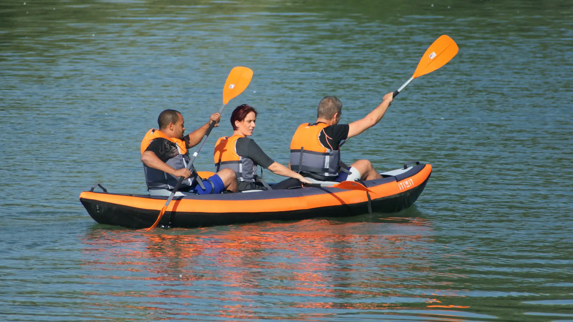 3 persons kayaking on an inflatable kayak