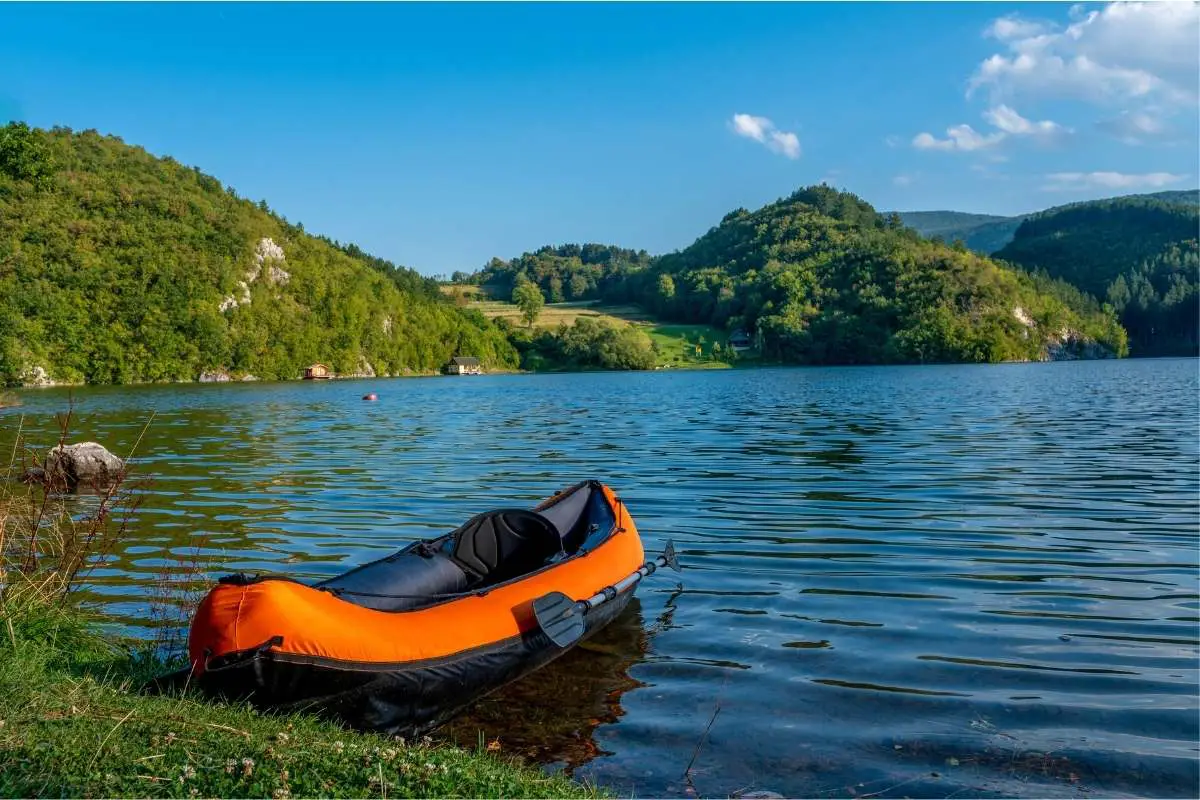 orange kayak rowed to shore