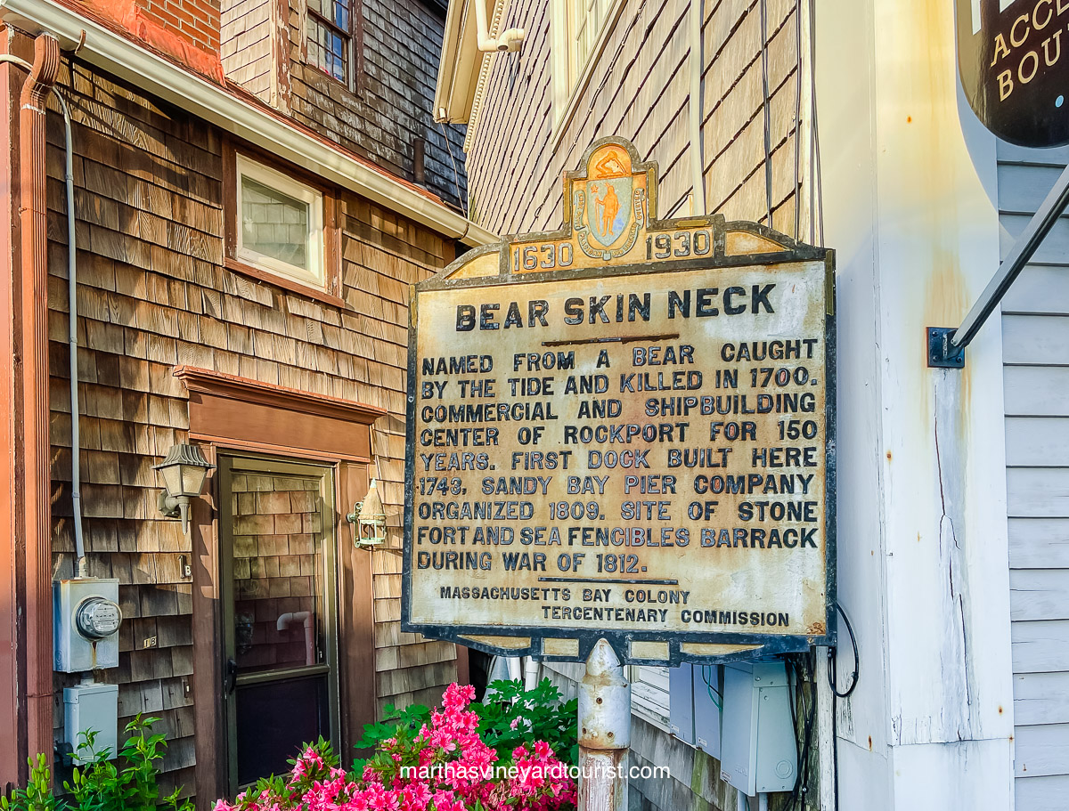 A sign explaining how Bear Skin Neck Rockport MA got its name.